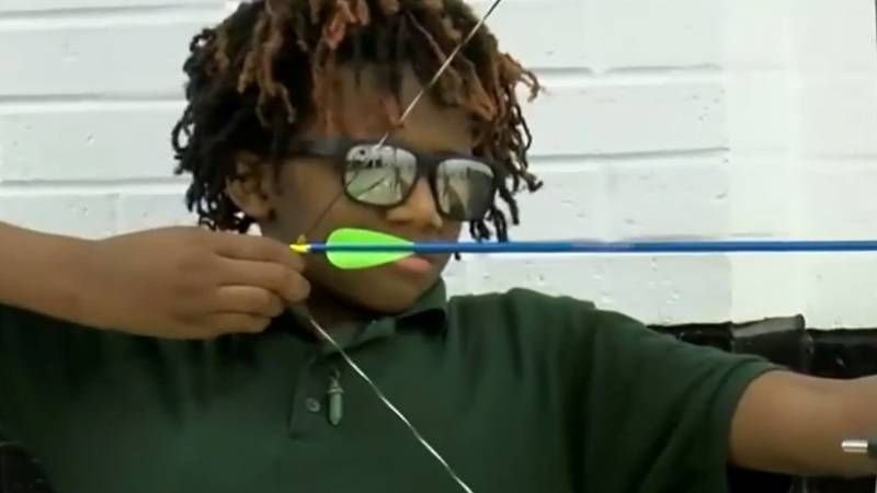 Kazyon Hinton pulls back on his bowstring moments before releasing an arrow toward a target on...