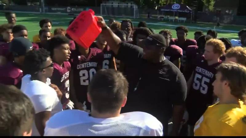 Gents head coach Byron Dawson holds up gas can to inspire team after practice